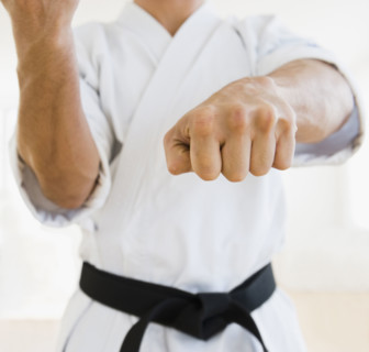 Male karate black belt in fighting stance.