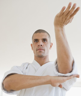 Hispanic man in karate fighting stance.