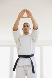 Hispanic male karate black belt in stance.