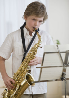 Boy playing saxophone.