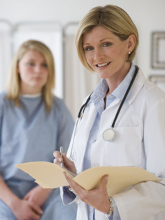 Female doctor holding chart.
