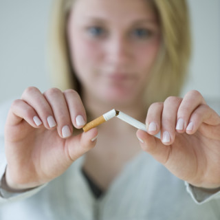 Woman breaking cigarette.