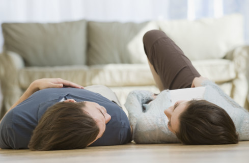 Couple laying on floor.