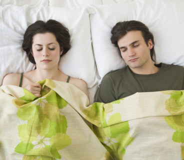 Couple sleeping in bed.