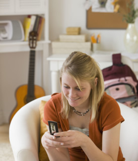 Teenaged girl looking at cell phone.