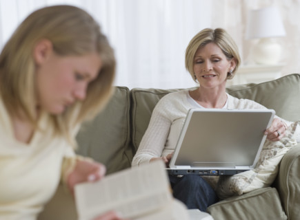 Mother and daughter relaxing in livingroom.
