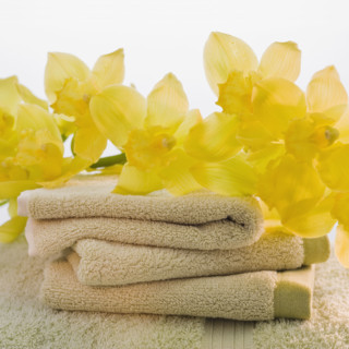 Flowers on stack of towels.