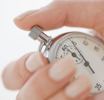 Woman holding stopwatch.
