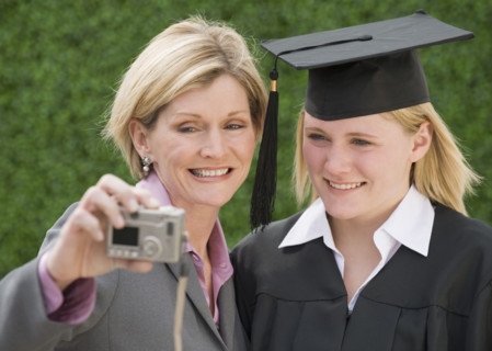 Mother and graduate daughter taking own photograph.