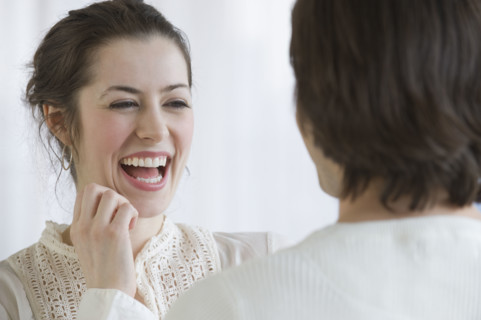 Woman laughing next to boyfriend.