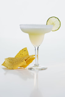 Margarita next to tortilla chips.