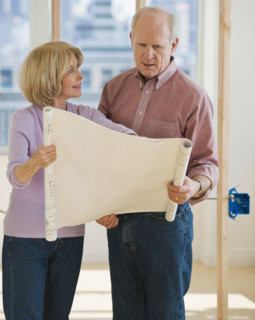 Senior couple looking at blueprints.