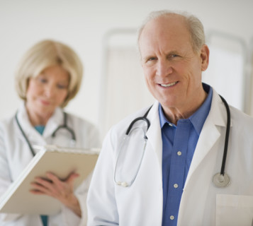 Senior male doctor with stethoscope around neck.
