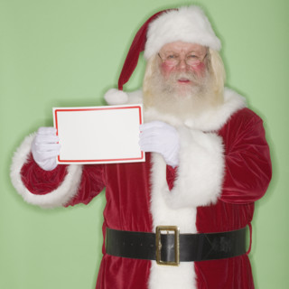 Santa Claus holding blank sign.