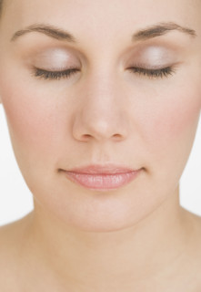 Close up of woman with eyes closed.
