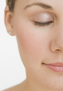 Close up of woman with eyes closed.