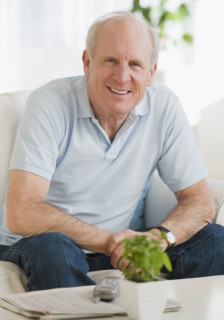 Senior man sitting on sofa.