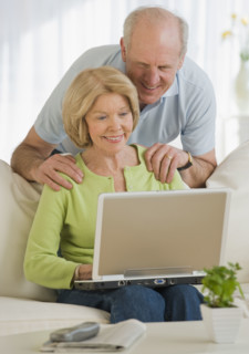 Senior couple looking at laptop.