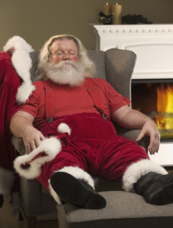Santa Claus relaxing in armchair.