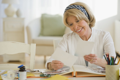Senior woman looking at photographs.