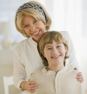 Grandmother hugging grandson.