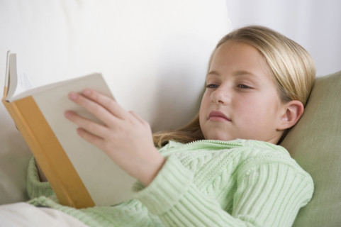 Girl reading on sofa.
