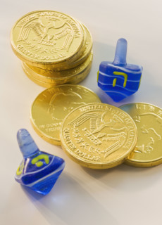 Close up of Chanukah coins and dreidels.