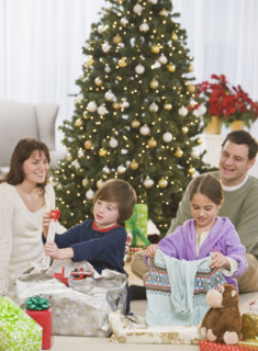 Siblings opening Christmas gifts.