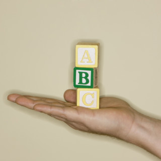Man holding ABC blocks.