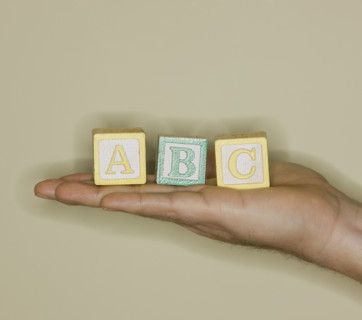 Man holding ABC blocks.