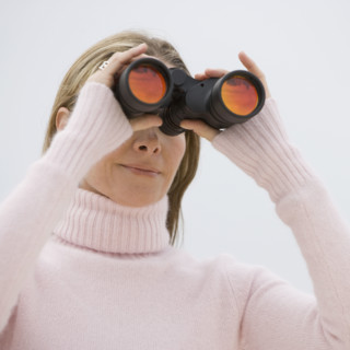 Woman looking through binoculars.