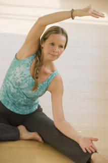 Woman stretching on floor.