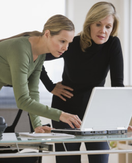 Businesswomen looking at laptop.