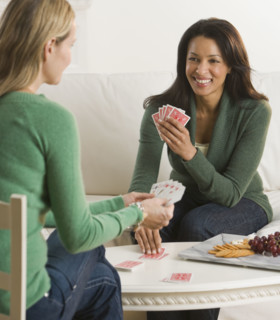Multi-ethnic women playing cards.