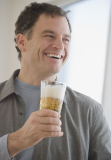 Man holding glass of beer.