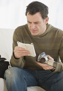 Man reading camera manual.