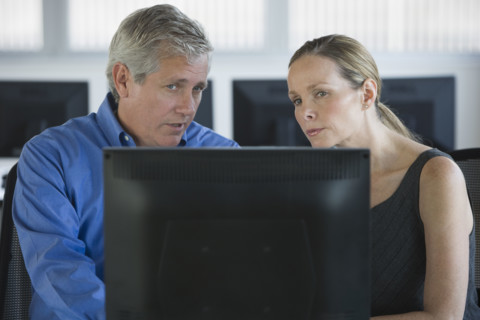 Businesspeople looking at laptop.