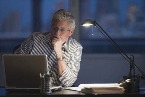 Businessman looking at laptop.