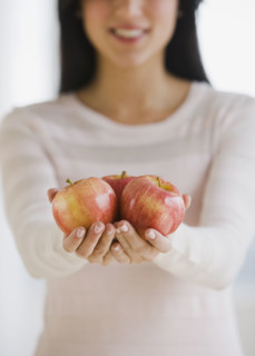 Woman holding apples.