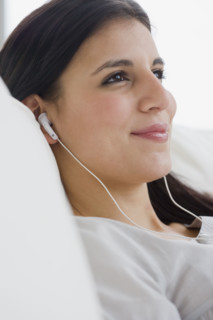 Woman listening to mp3 player.