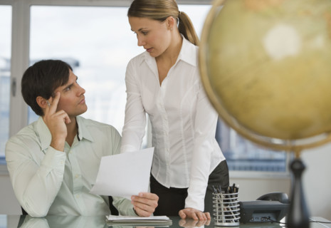 Businesspeople discussing paperwork.