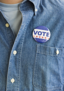 Vote pin on man’s shirt.