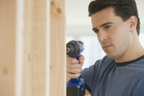 Man using cordless drill.