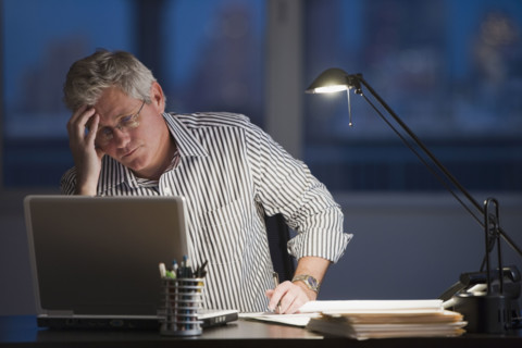 Businessman looking at laptop.