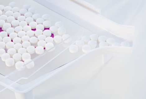 Close up of pills in measuring device.