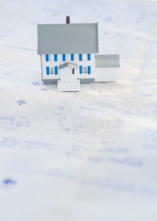 Model house on blueprints.