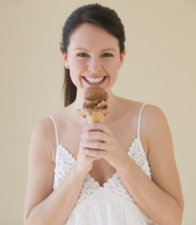 Woman eating ice cream cone.