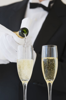Waiter pouring champagne.