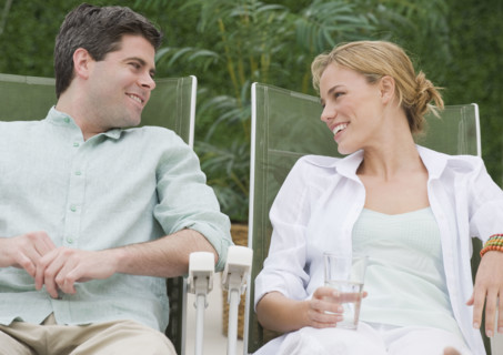 Couple relaxing in lounge chairs.
