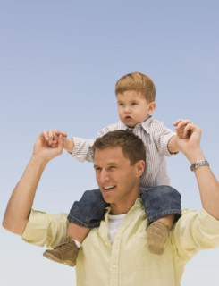 Father holding son on shoulders.